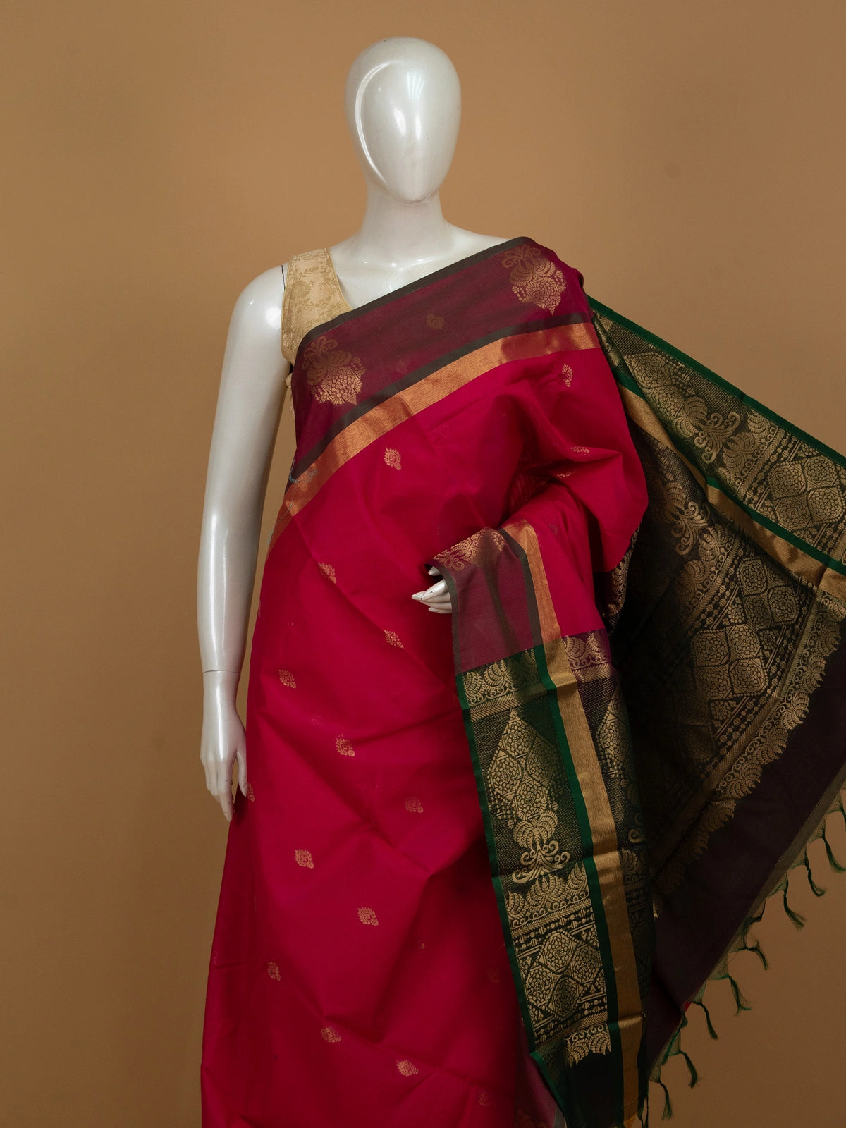 Rani pink silk cotton saree with contrast green and gold zari border and pallu