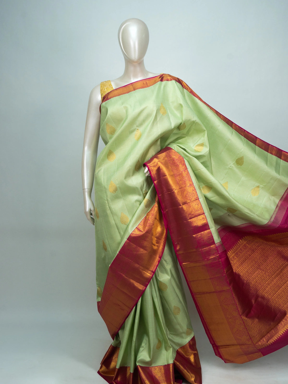 Pastel green pure Kanchipuram silk saree with contrast pink gold zari border and brocade pallu