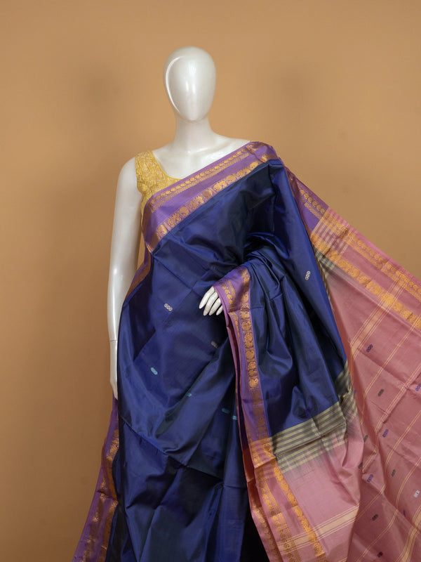 Navy blue banana silk saree with mauve-pink contrast pallu and gold zari peacock border