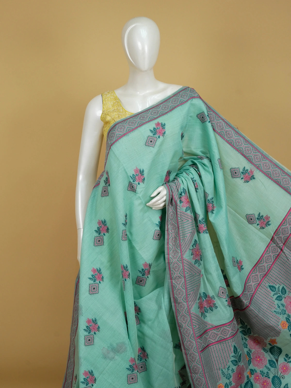 Mint green linen cotton saree with pink floral prints and geometric diamond border