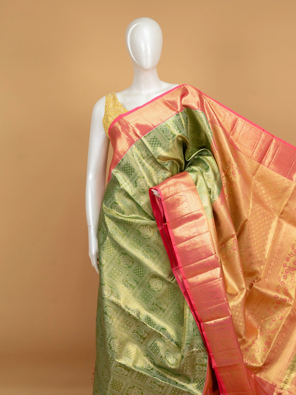 Green pure Kanchipuram silk saree with contrast pink border and gold zari brocade body and pallu