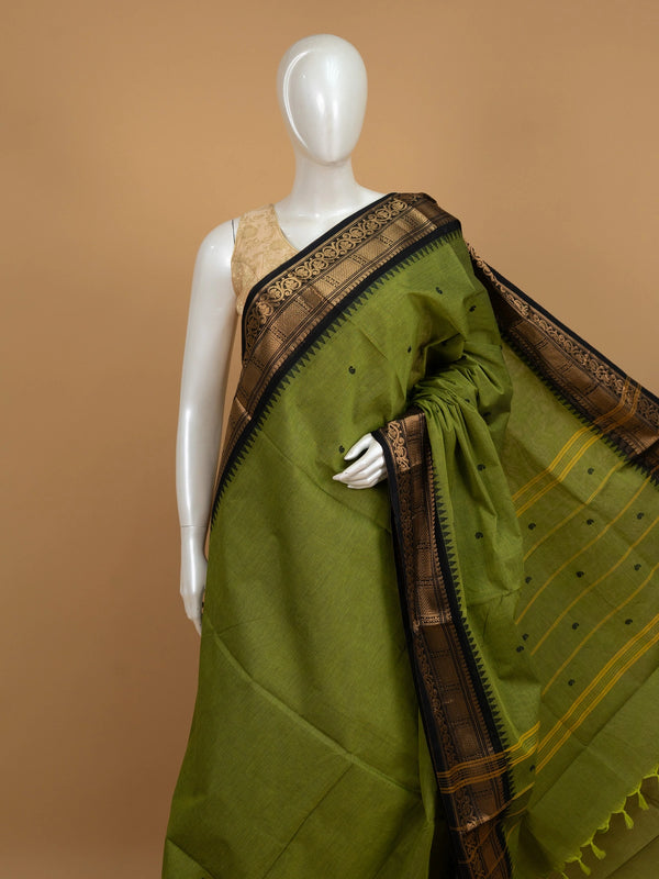 Olive green Chettinad cotton saree with black and gold zari contrast border and paisley buttas