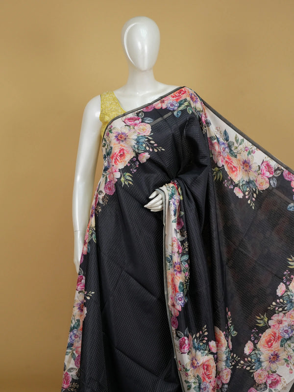 Black semi tussar saree with multicolour floral printed border and pallu on a cream ground