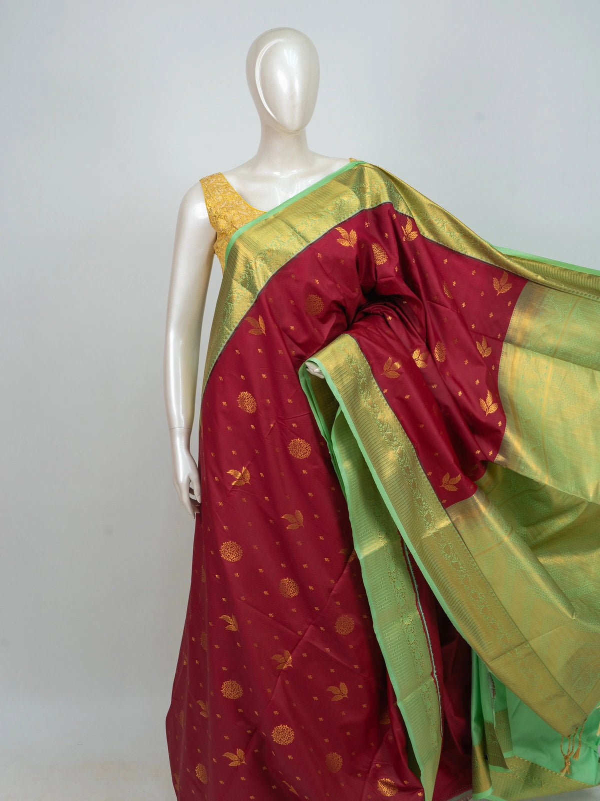 Maroon semi silk saree with gold zari buttas and contrast green zari border and pallu