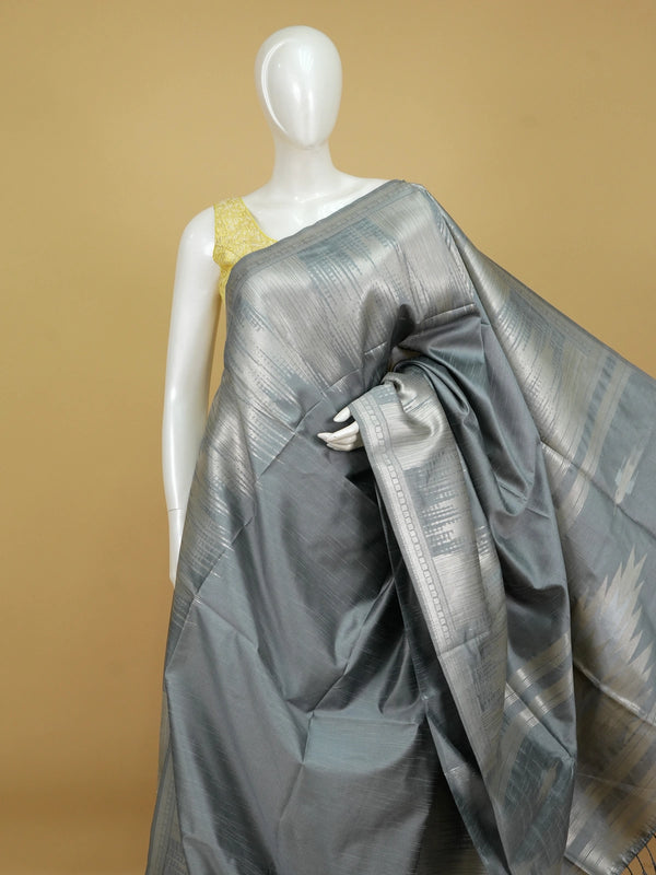 Grey semi tussar saree with silver zari border and temple-motif pallu