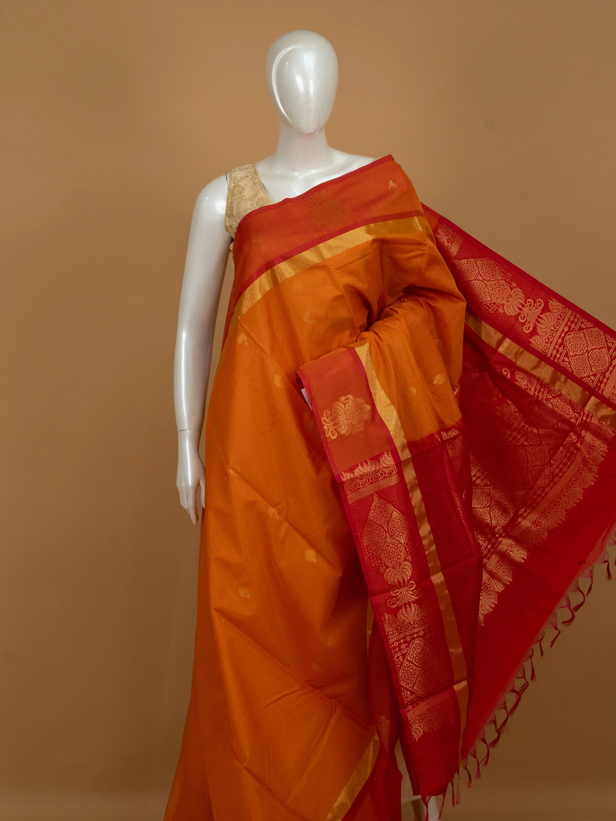Orange silk cotton saree with contrast red gold zari pallu and border