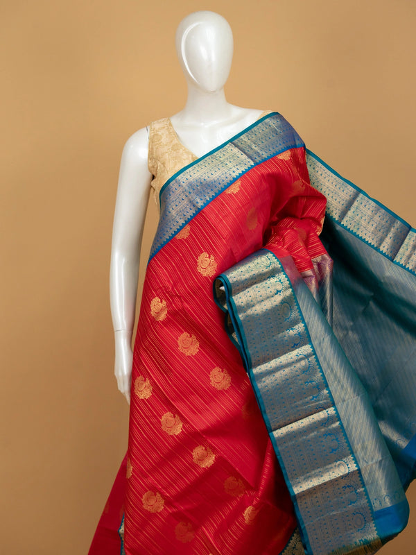 Red pure Kanchipuram silk saree with gold zari buttas and a contrast peacock-blue zari border
