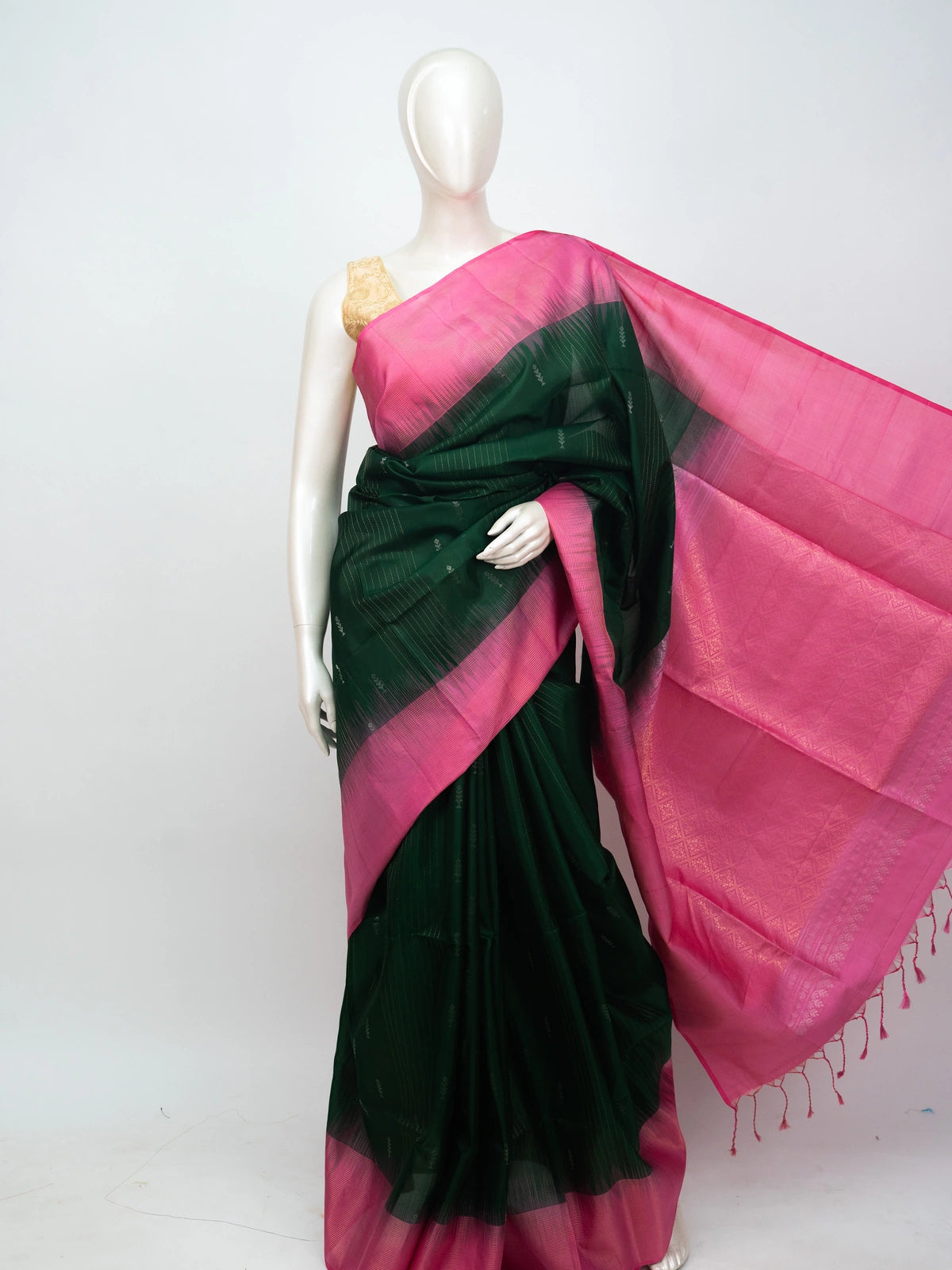 Bottle green soft silk saree with contrast pink zari border and tasselled pallu