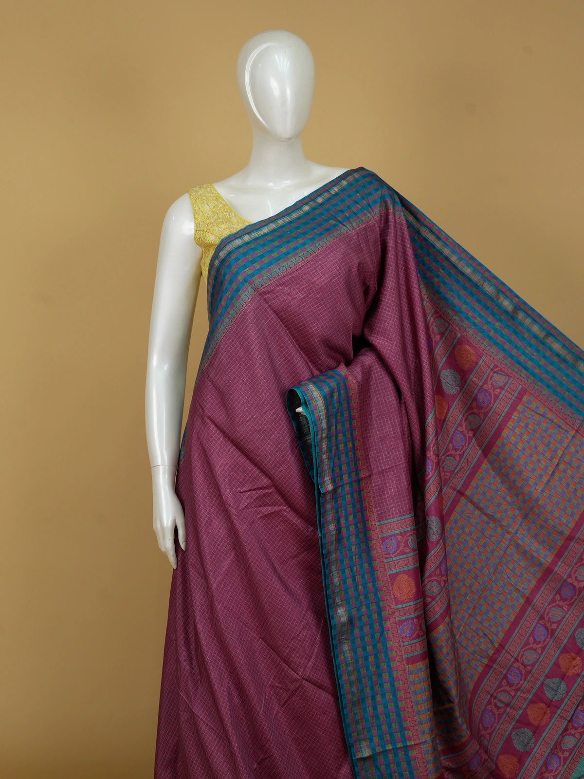 Magenta pink Dola silk saree with teal-blue contrast checked border and floral motif pallu