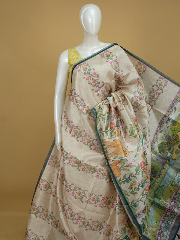 Cream semi tussar saree with floral print, teal border and pichwai landscape pallu