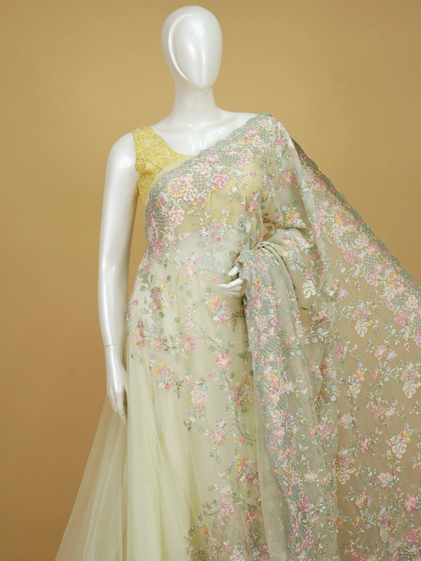 Pastel lemon-green designer net saree with multicolour floral embroidery and scalloped sequin border
