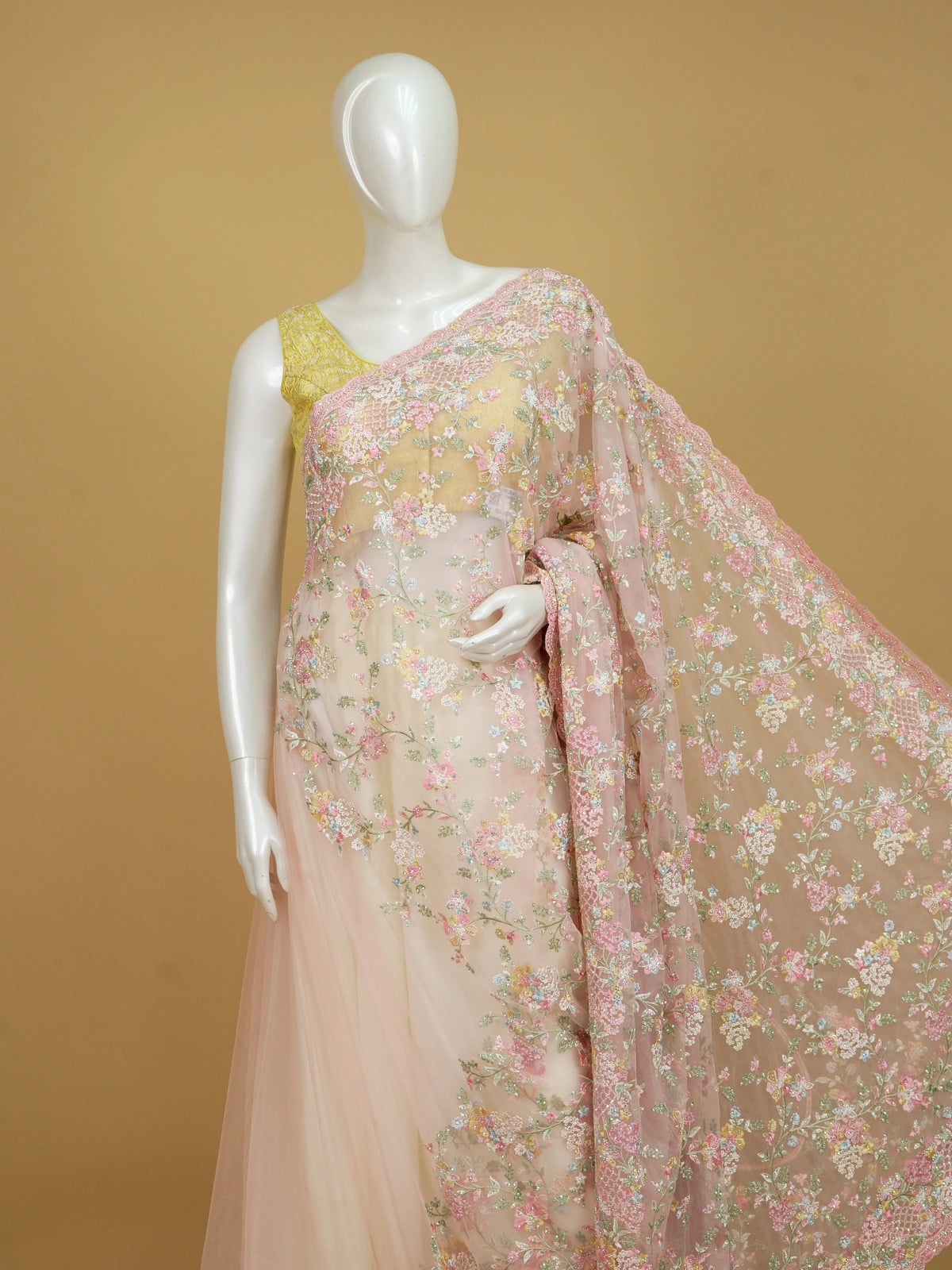 Soft pink net designer saree with pastel multicolour floral embroidery and scalloped border