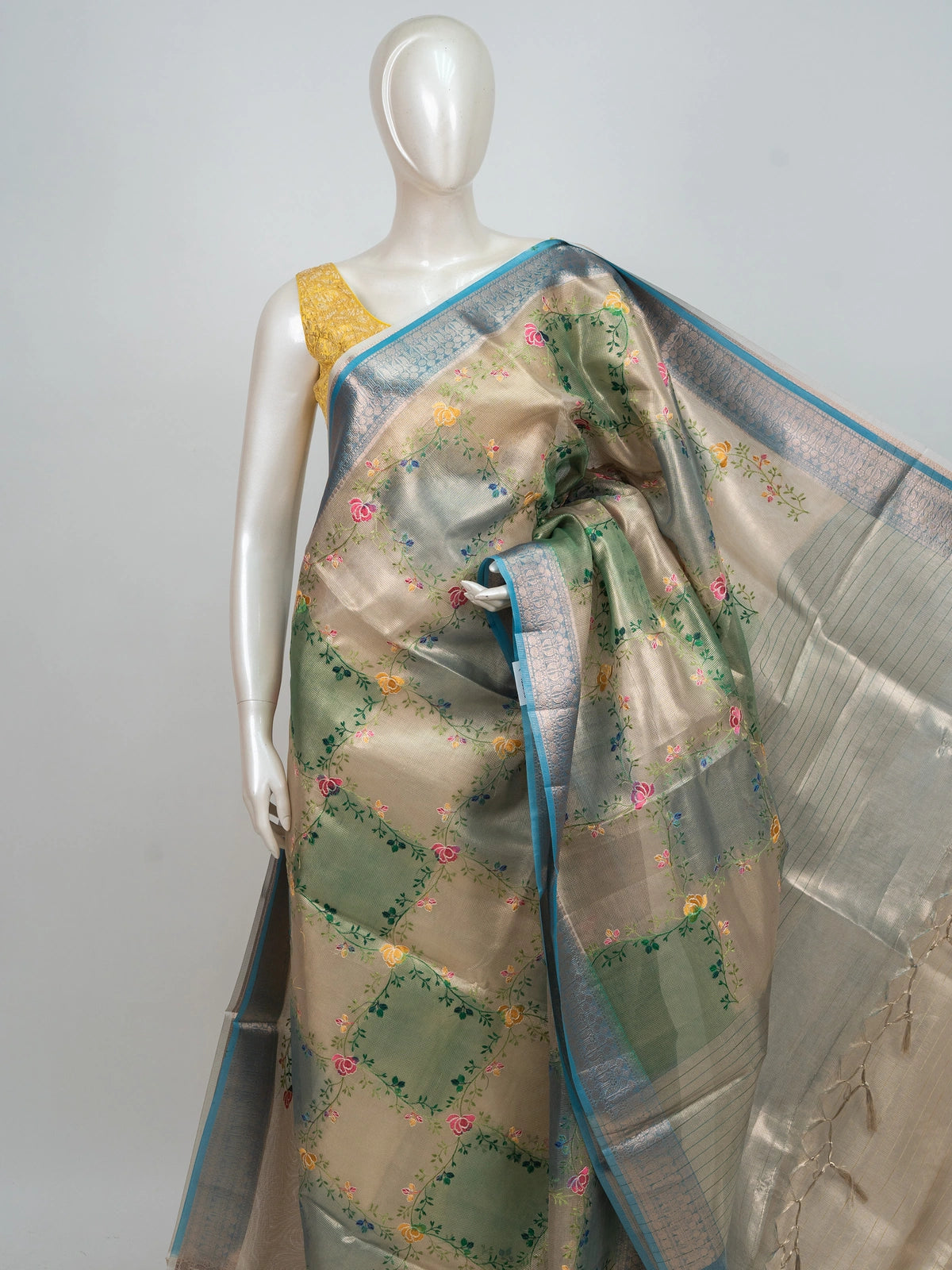 Beige and teal blue semi raw silk saree with multicoloured floral embroidery and silver zari border