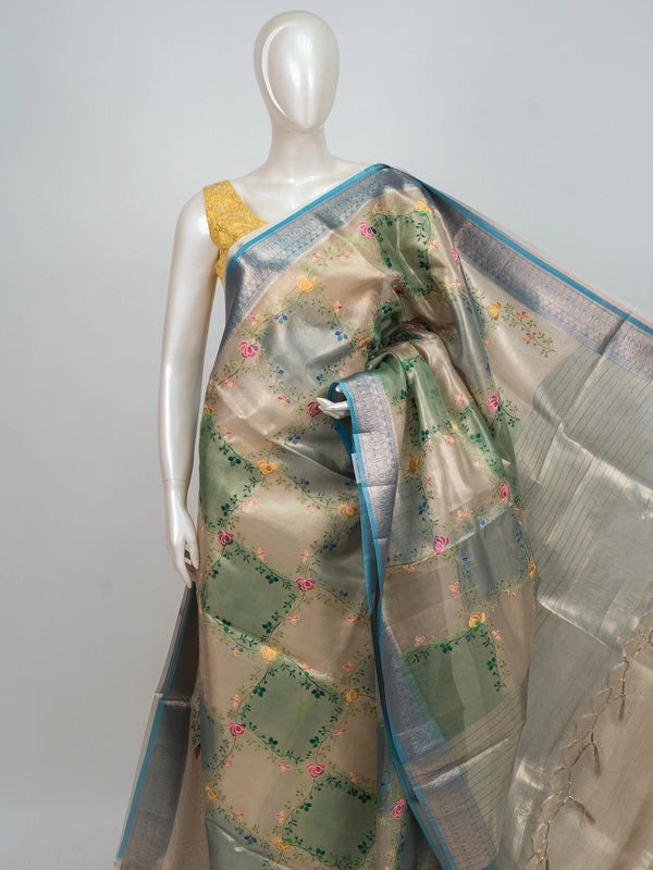 Beige and teal blue semi raw silk saree with multicoloured floral embroidery and silver zari border