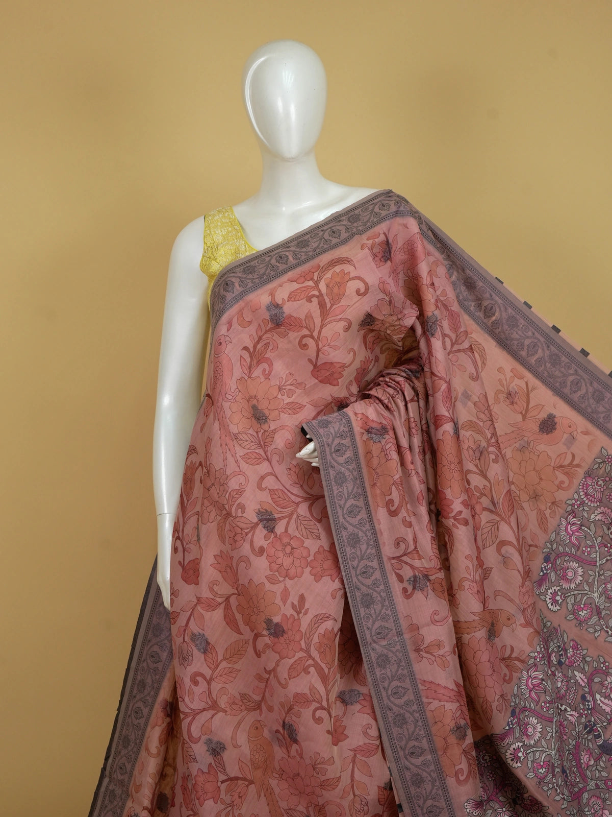Peach and grey floral printed linen cotton saree with Kalamkari-style parrot motifs and contrast border