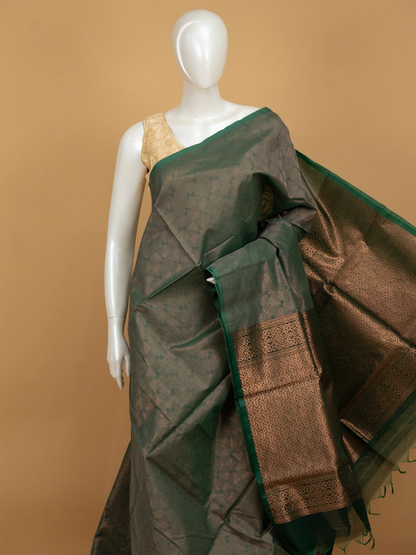Dark green silk cotton saree with copper-gold zari border and geometric woven pallu