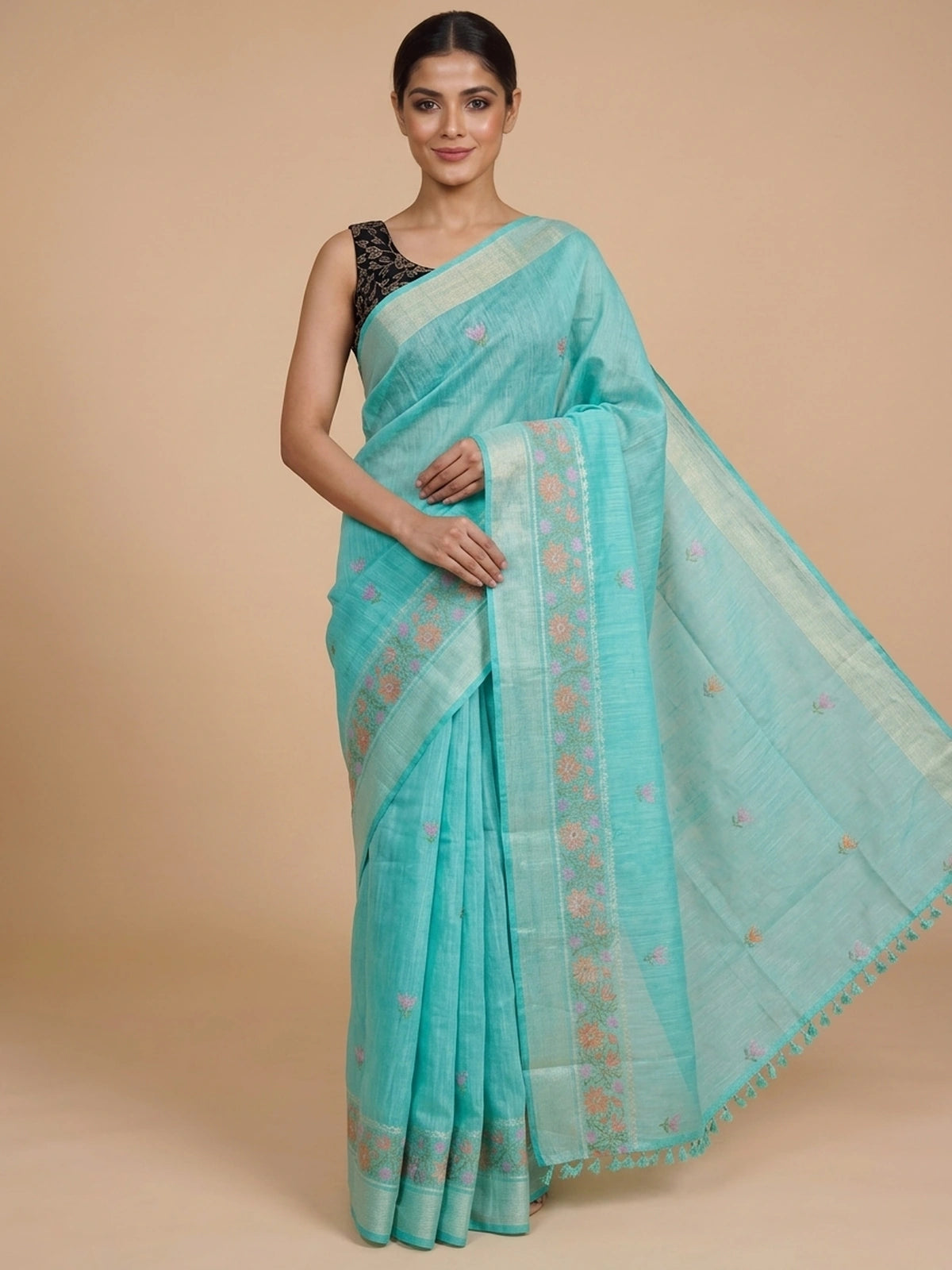 Turquoise linen cotton saree with silver zari border, floral embroidered buta and embroidered pallu, styled with a black blouse