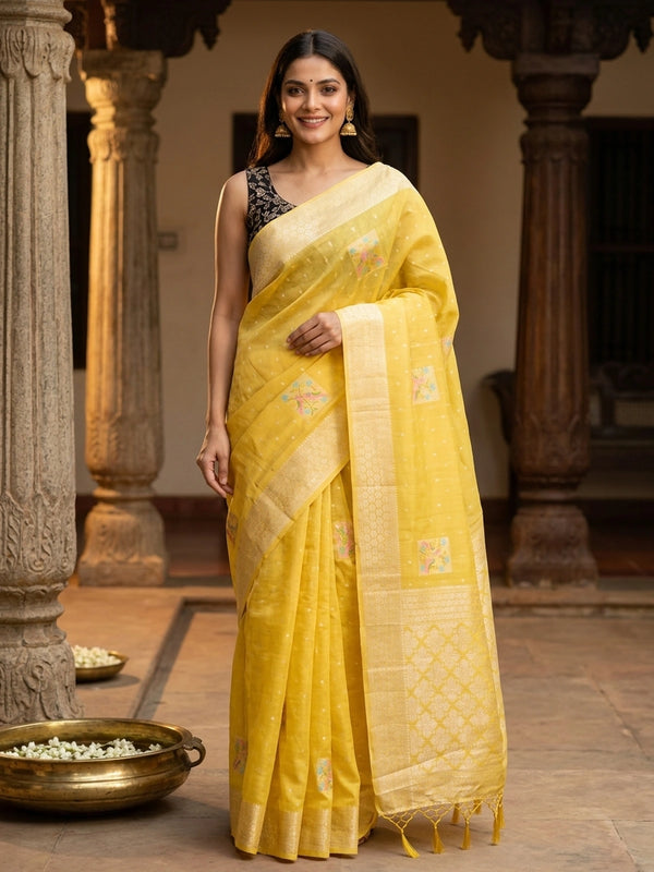 Bright yellow linen cotton saree with gold zari border, buti dots and pastel bird-floral motifs