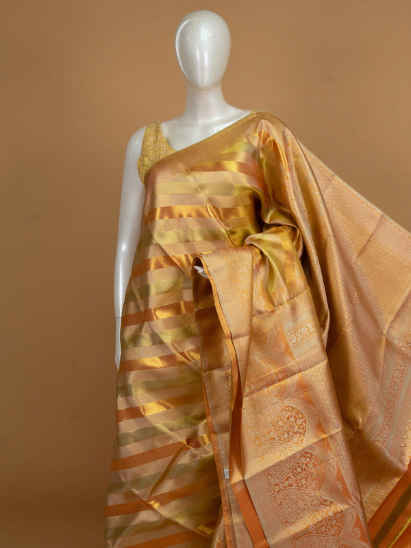 Gold and orange pure Kanchipuram silk saree with diagonal zari stripes and floral zari border