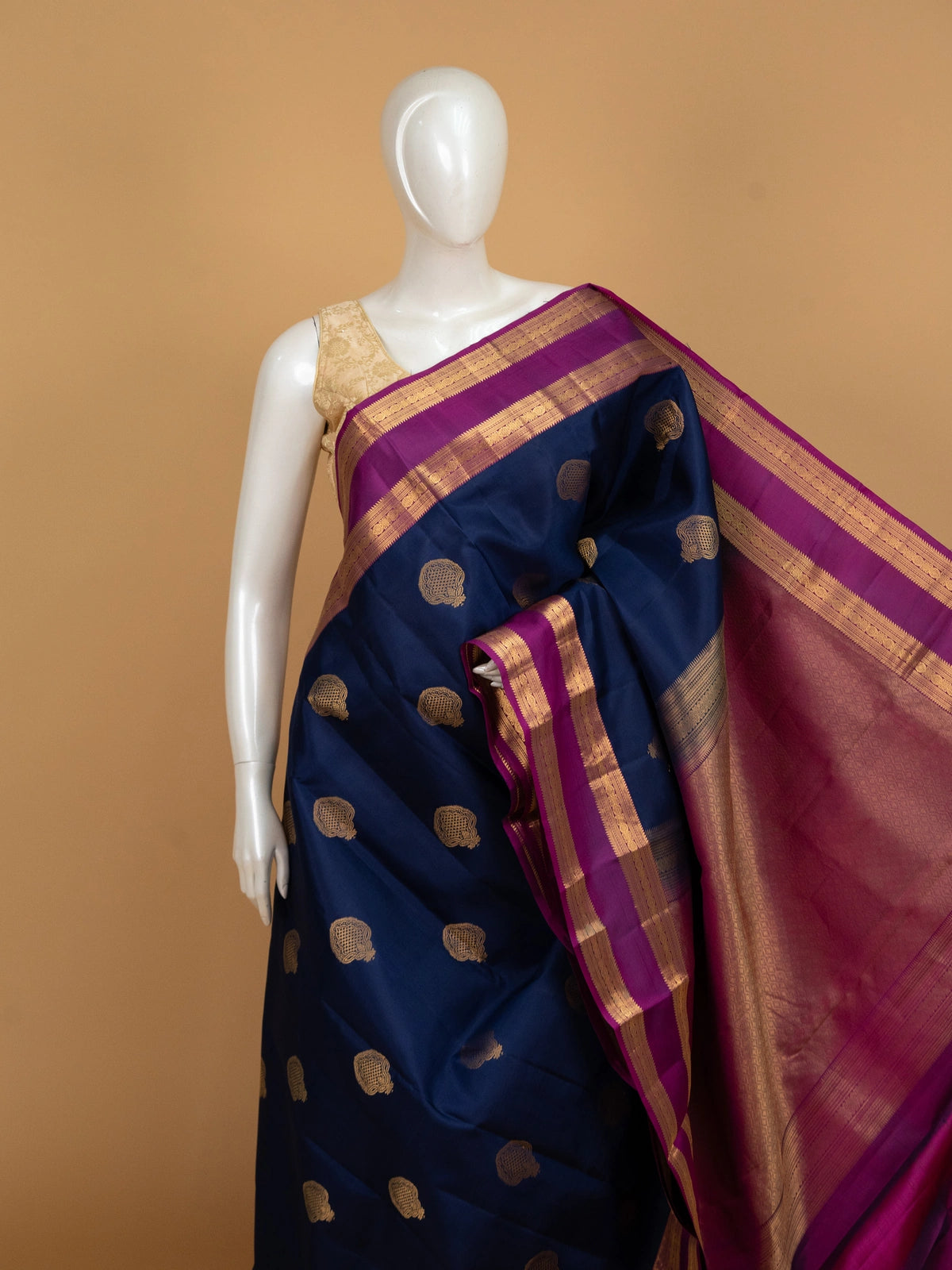 Navy blue pure Kanchipuram silk saree with magenta contrast border and gold zari buta motifs