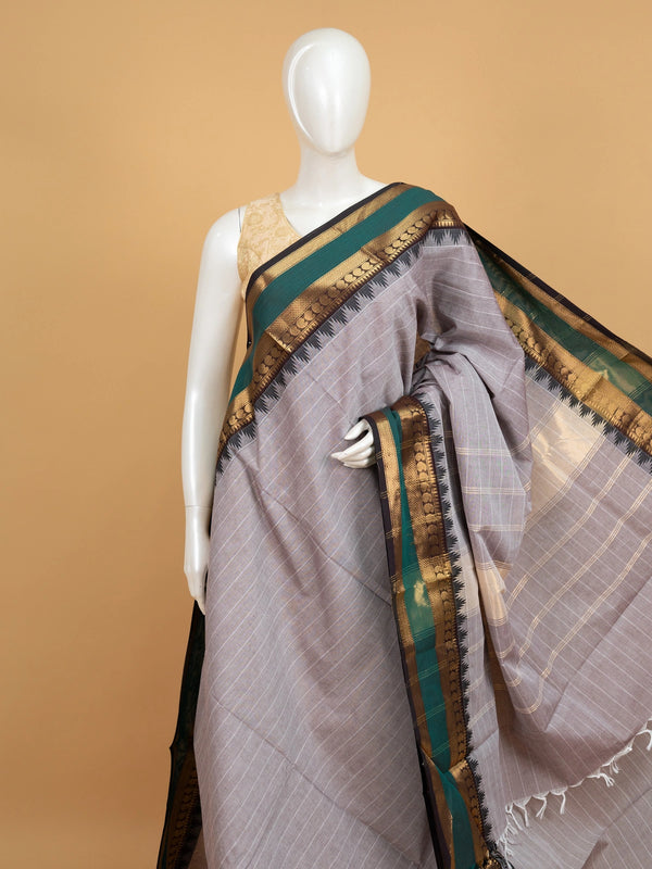 Grey Chettinad cotton saree with white checks and contrast green gold zari temple border