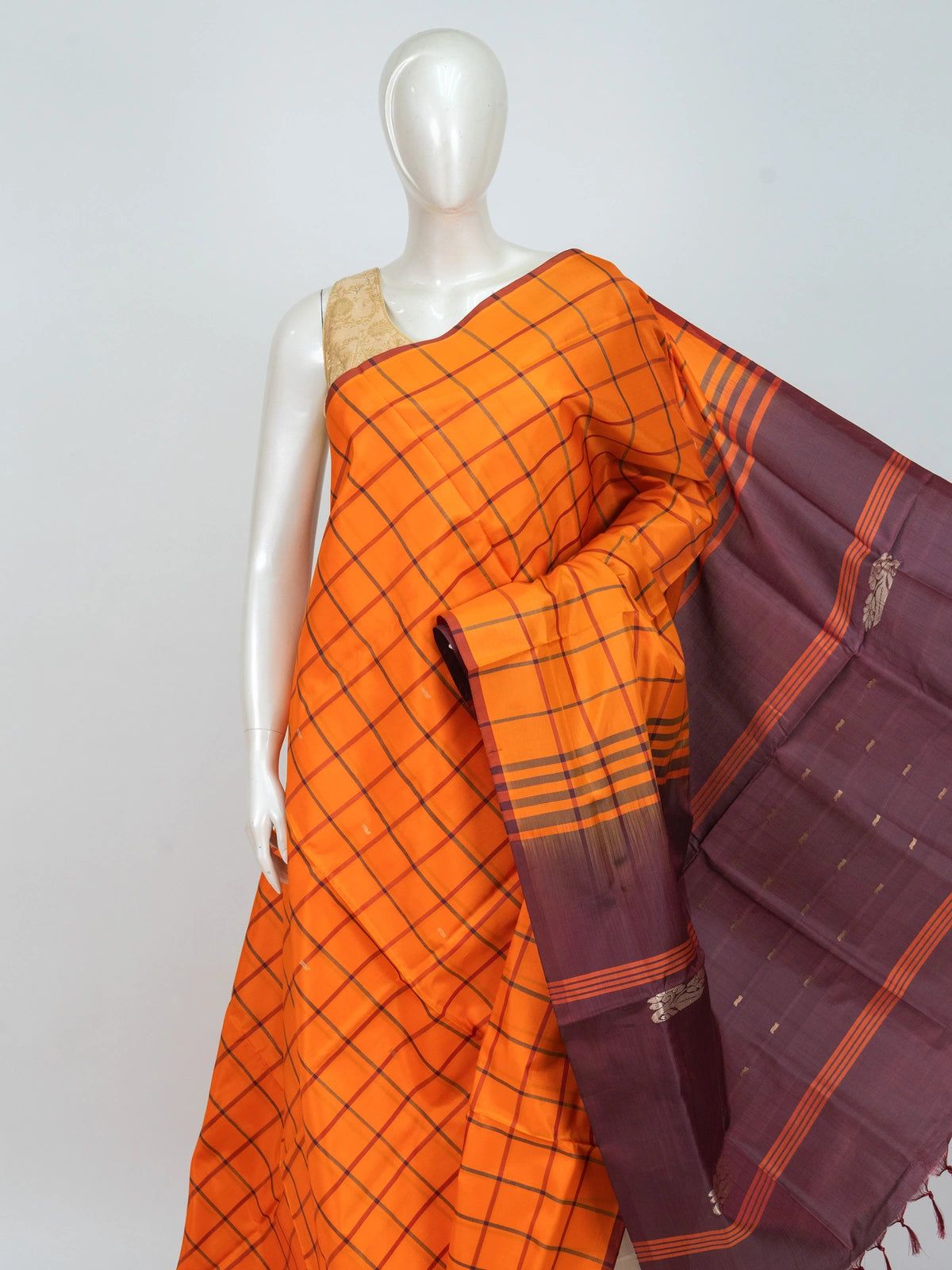 Orange checked banana silk saree with contrast maroon border and gold zari motif pallu