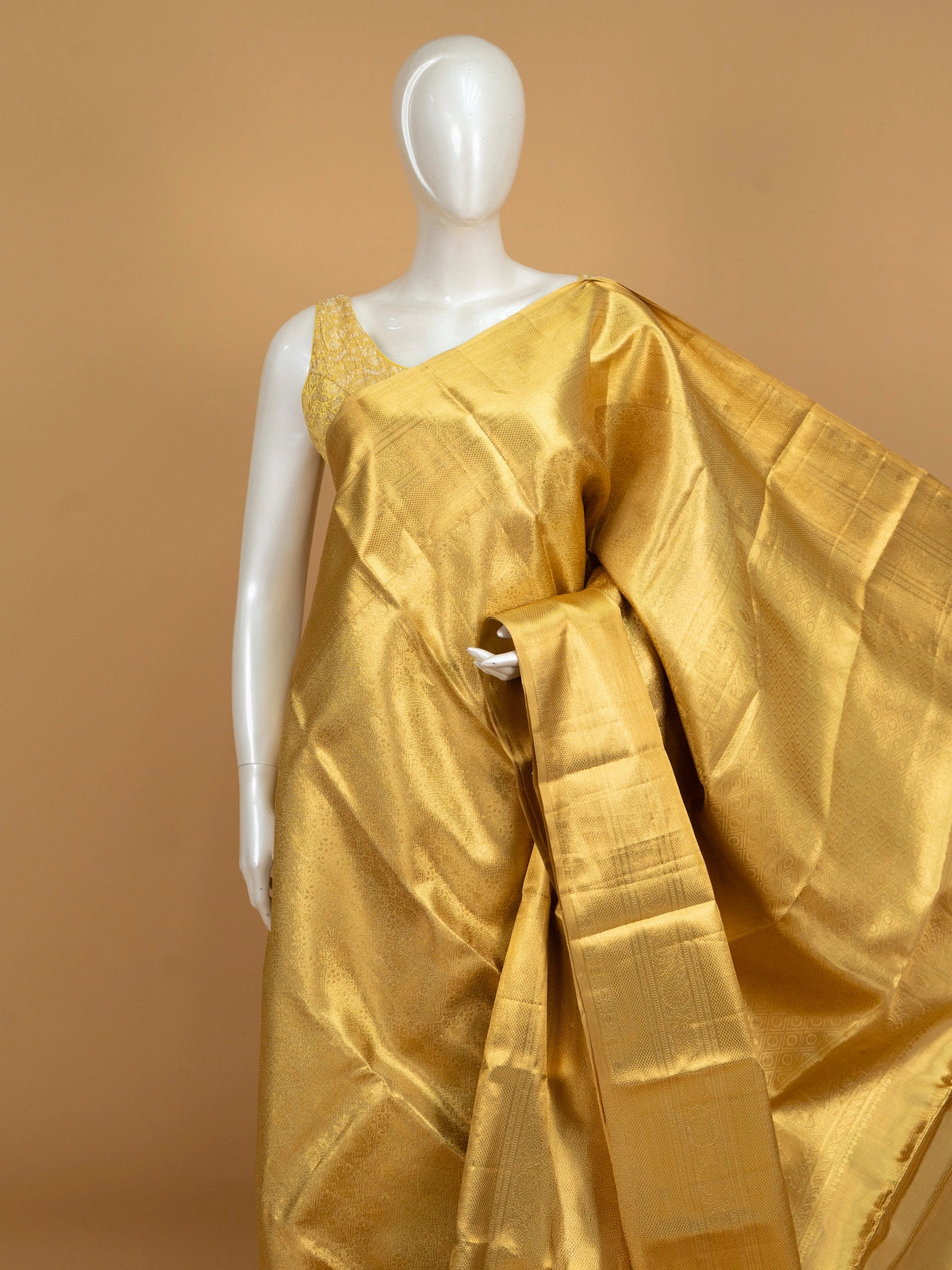 Gold pure Kanchipuram silk saree with all-over zari weave and ornate paisley-peacock pallu