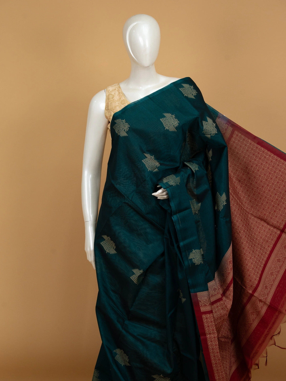 Teal green pure silk cotton saree with contrast maroon border, woven butta motifs, and geometric maroon pallu