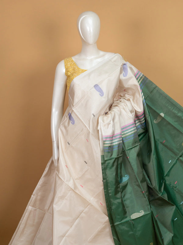Cream banana silk saree with multicolour paisley buttas and contrast green striped pallu and border