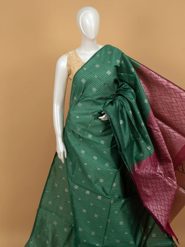 Green silk cotton saree with silver zari stripes and contrast magenta zari border and pallu