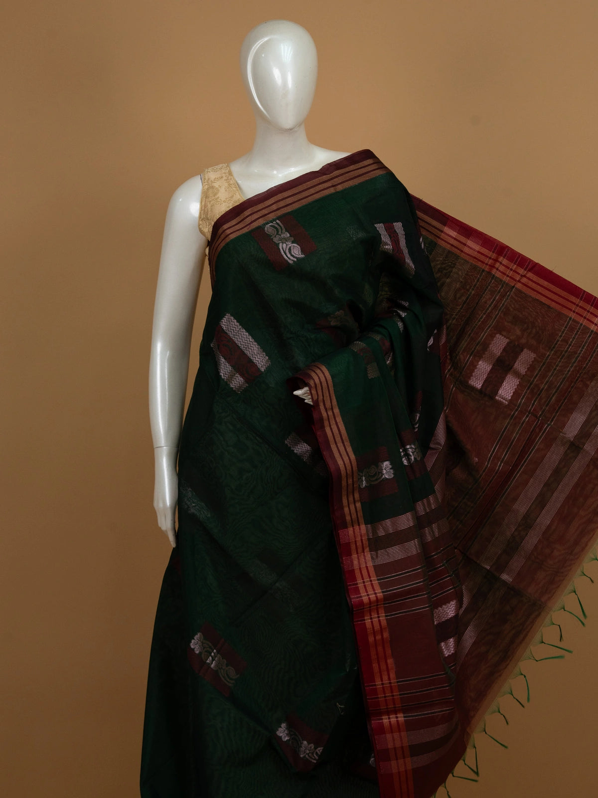 Dark green silk cotton saree with contrast maroon border, copper-gold stripes and silver woven buttas