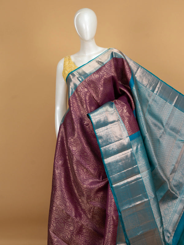 Purple pure Kanchipuram silk saree with silver zari floral weaving and contrast teal blue border and pallu