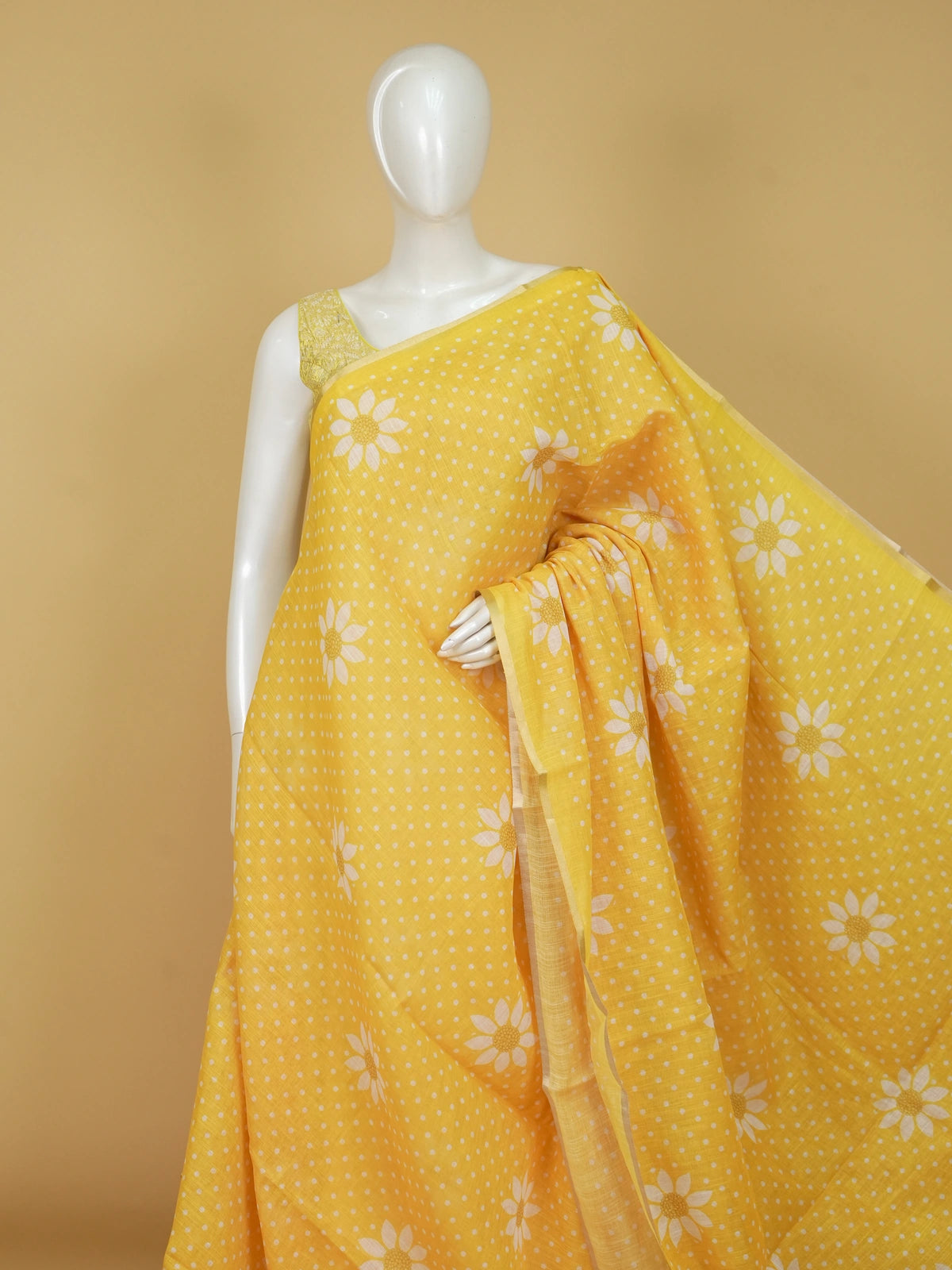 Yellow and white polka dot linen cotton saree with daisy floral prints and slim golden border