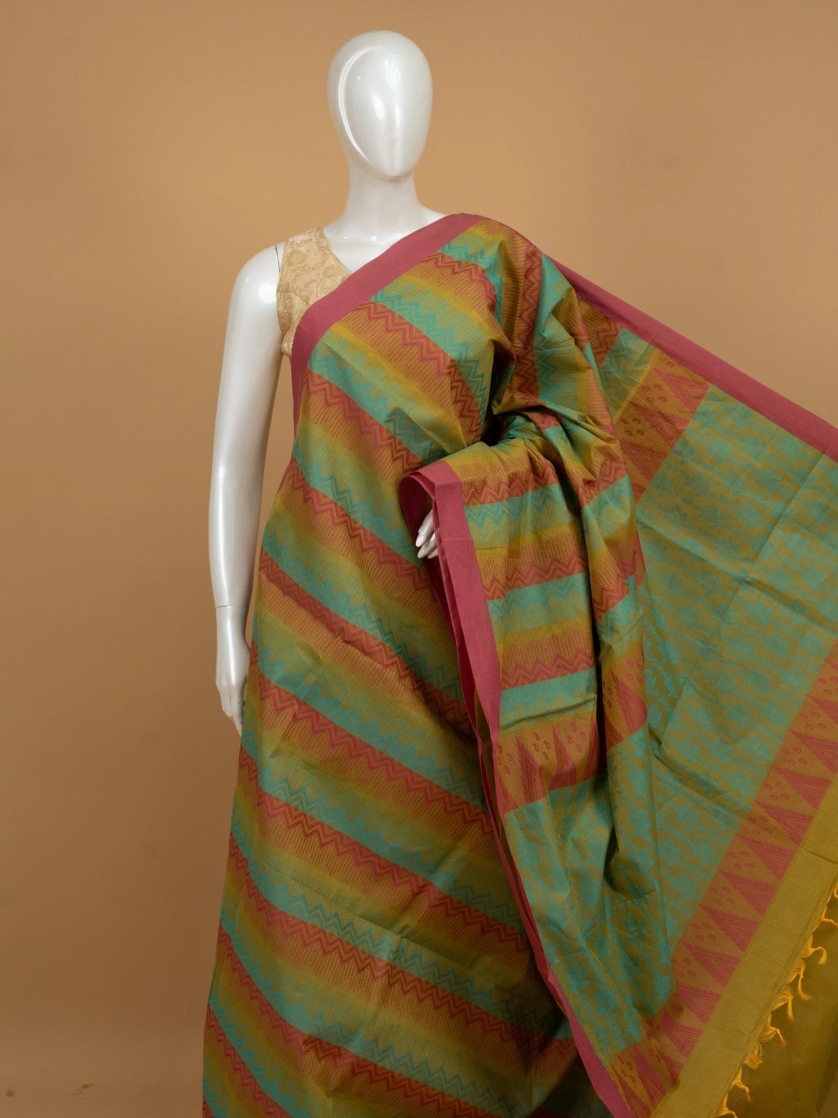 Mustard and pink silk cotton saree with turquoise chevron stripes and floral pallu
