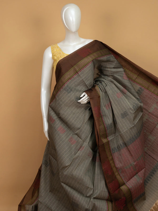 Grey and brown semi raw silk saree with striped body, woven buttas, and contrast temple-motif border