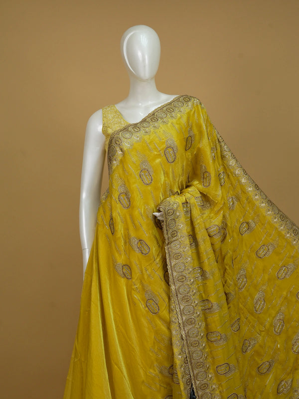 Yellow designer saree with gold zari and stone paisley motifs and embellished border
