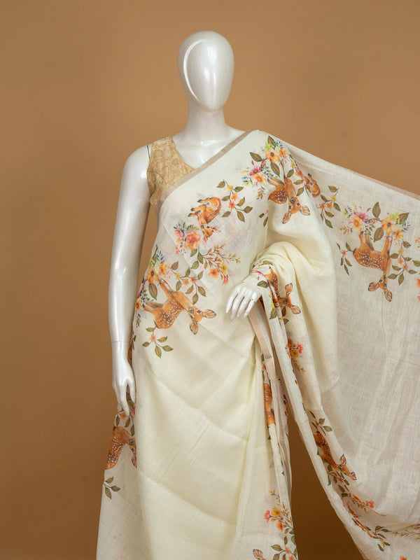Cream linen cotton saree with orange floral and spotted deer prints and a slim golden zari border