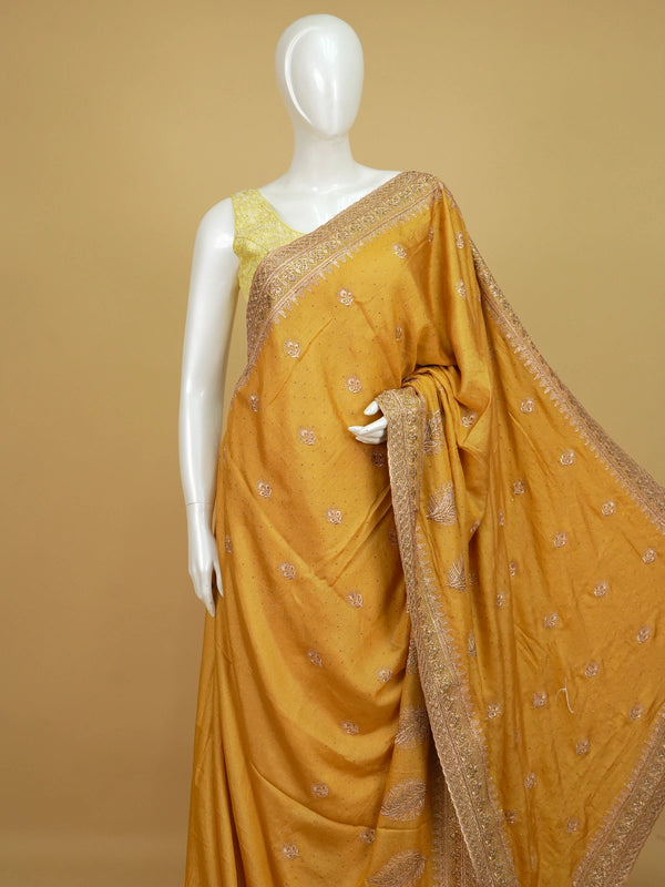 Mustard yellow designer saree with rose-gold embroidered butas, paisley pallu and embellished border
