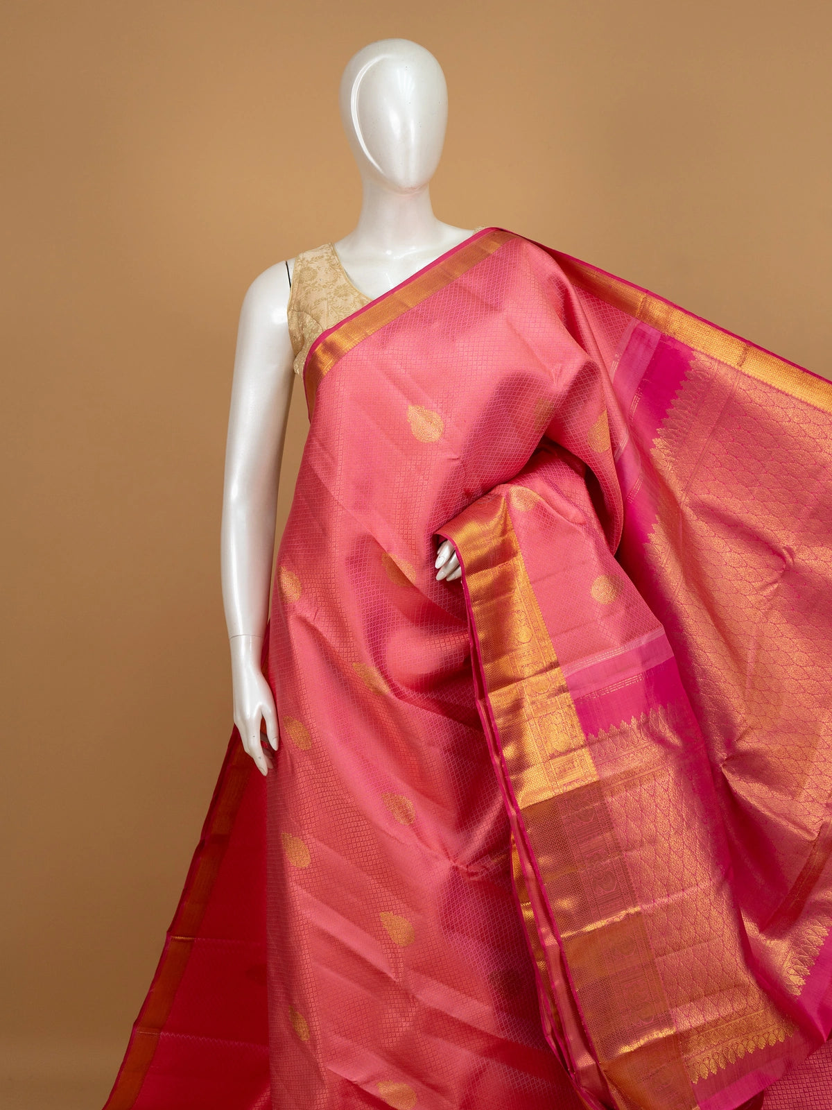 Coral pink pure Kanchipuram silk saree with gold zari buttas and contrast zari border