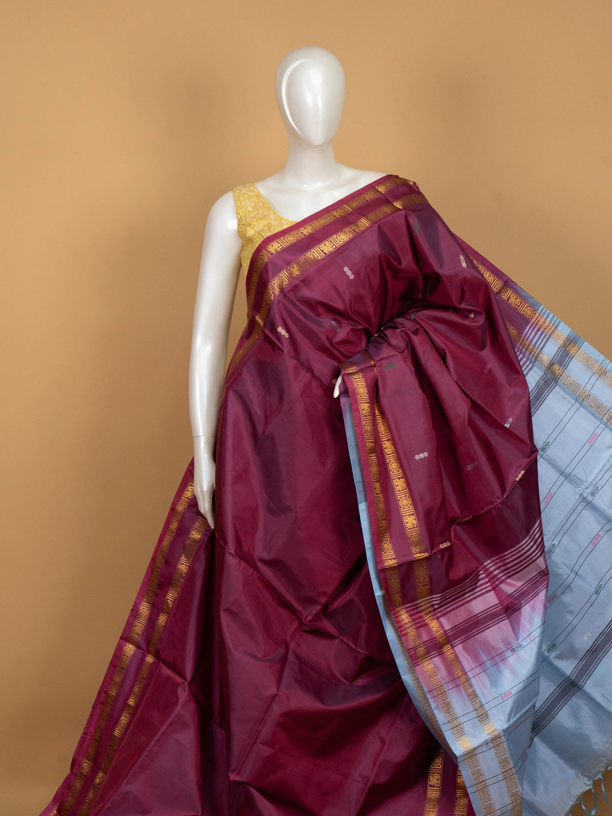Maroon banana silk saree with gold zari border and contrast grey-blue pallu