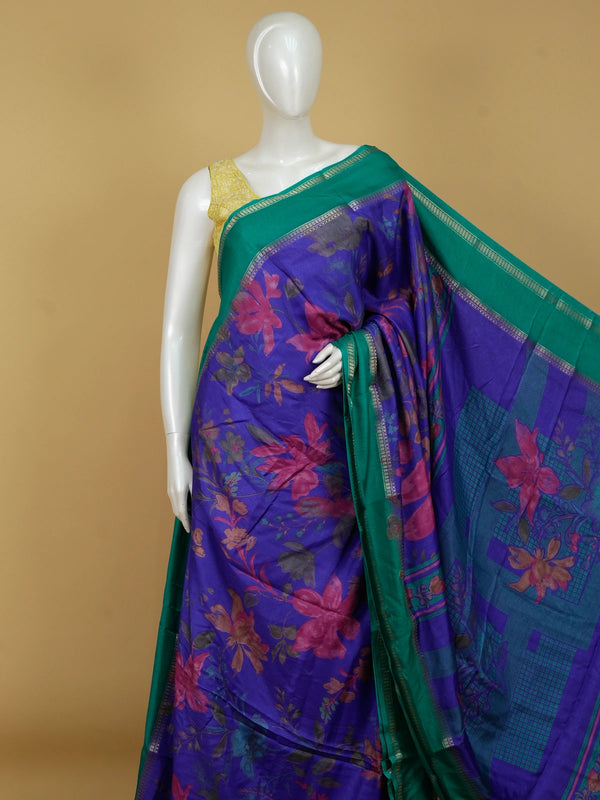 Violet blue Dola silk saree with floral print body and contrast teal green gold zari border