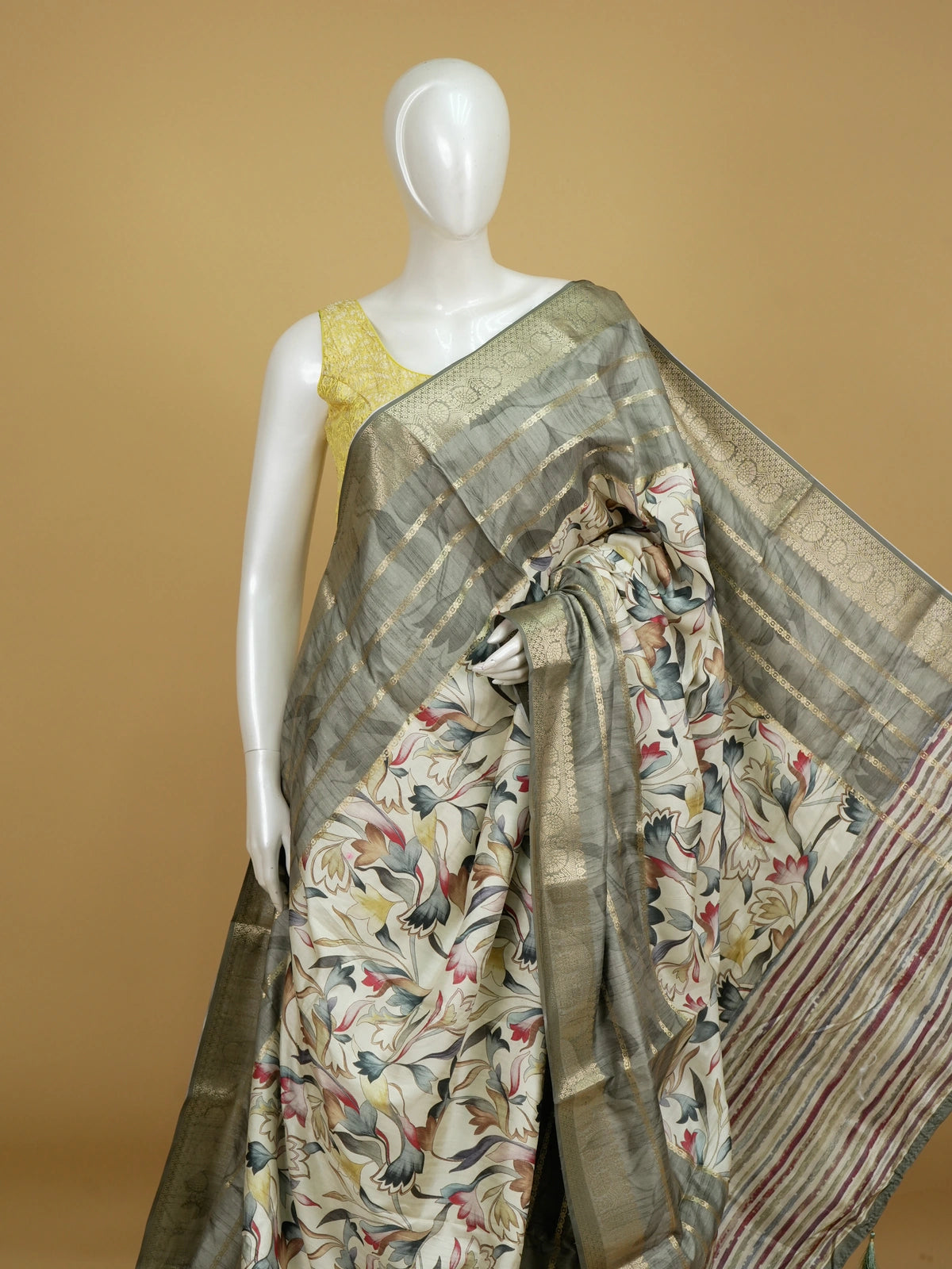 Cream semi tussar saree with multicolour floral print and grey gold zari border