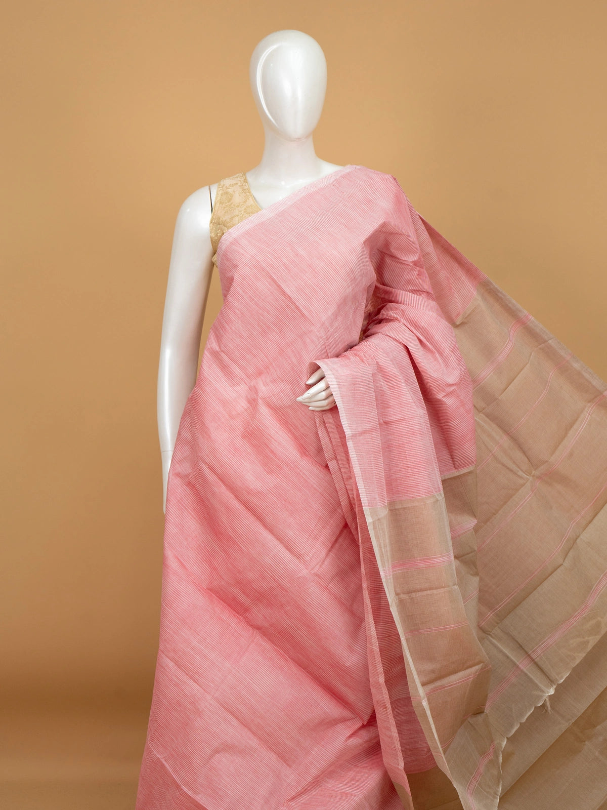 Pink and beige silk cotton saree with fine striped body, contrast beige pallu and golden-lined border
