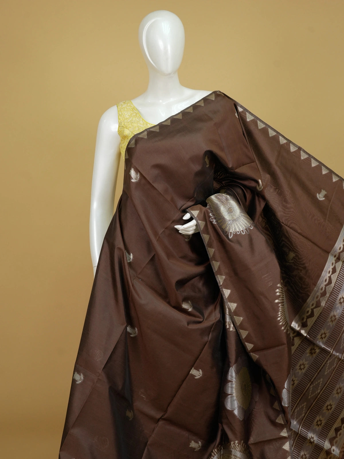 Brown semi tussar saree with gold and silver zari buttas, temple border and floral medallion pallu