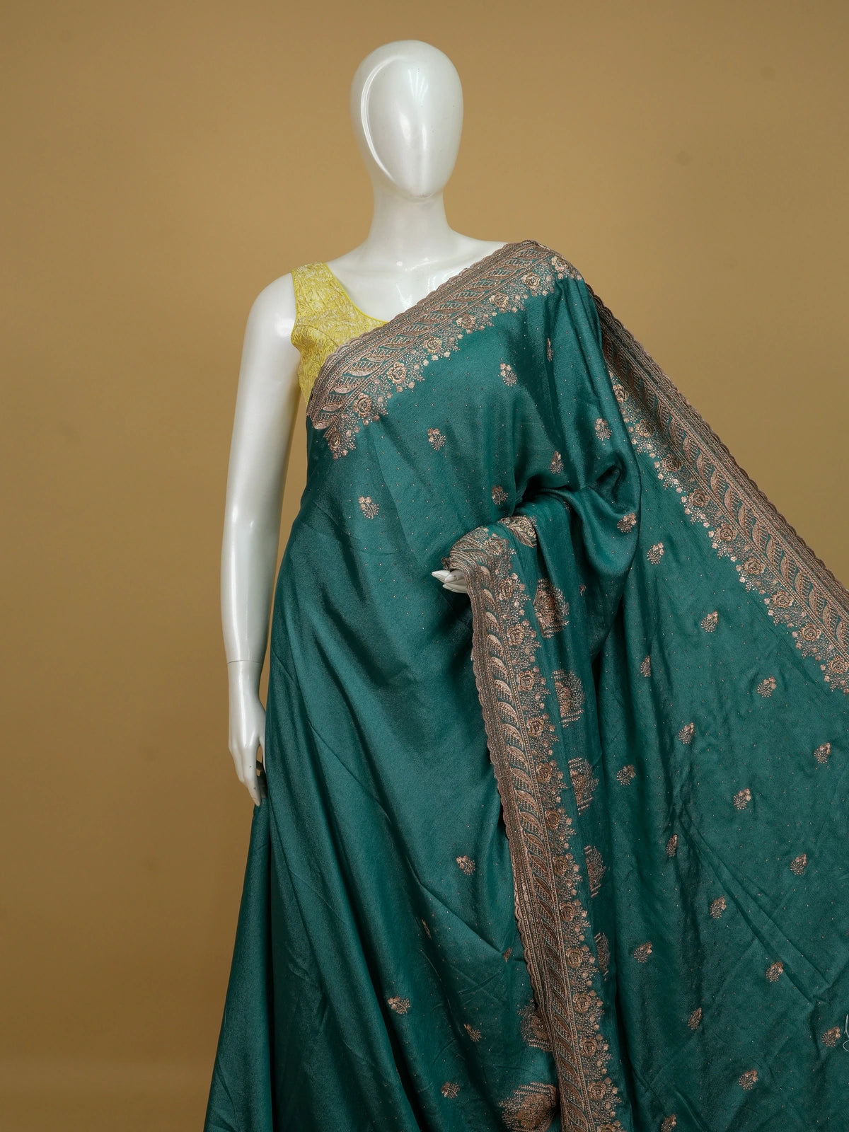 Teal green designer saree with copper floral embroidery, sequin work and scalloped embroidered border