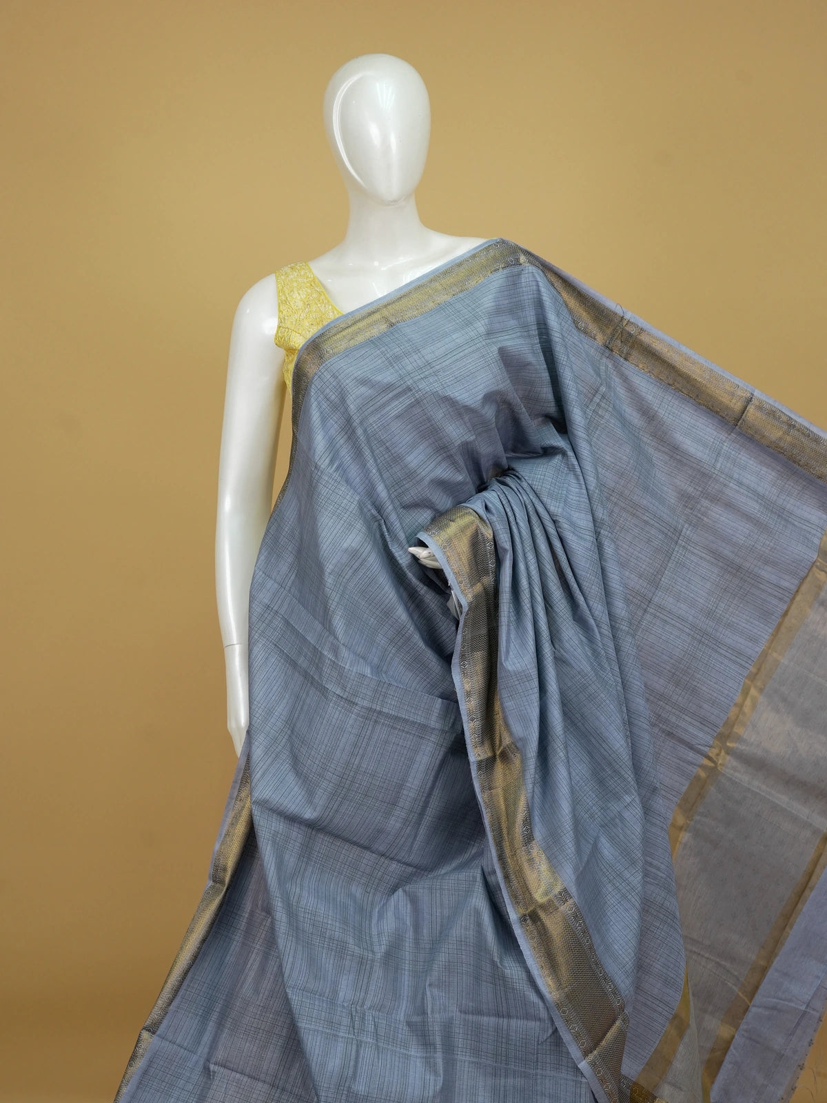 Grey semi tussar saree with crosshatch weave and gold zari border