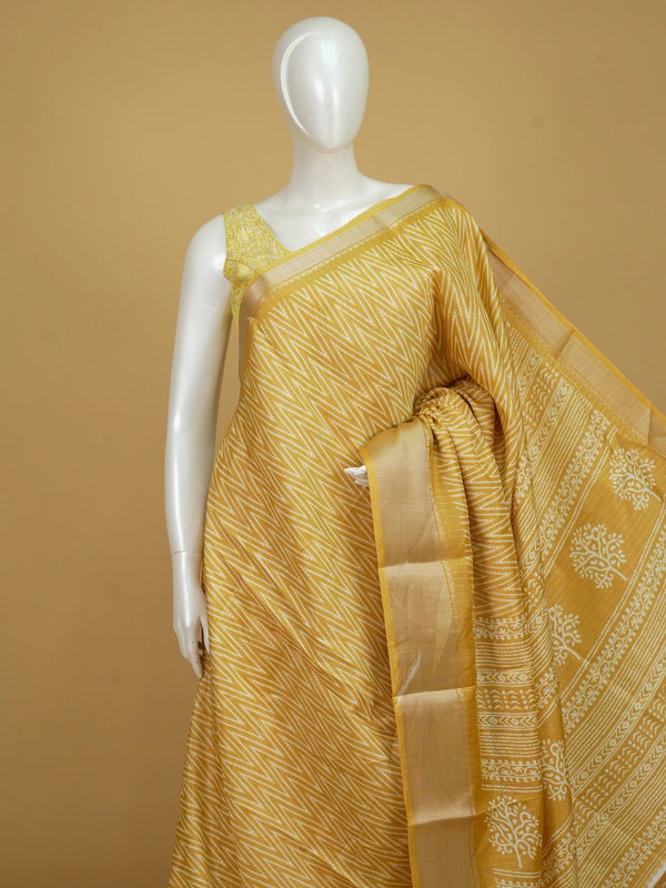 Yellow and white designer saree with zigzag print, gold zari border and tree motif pallu