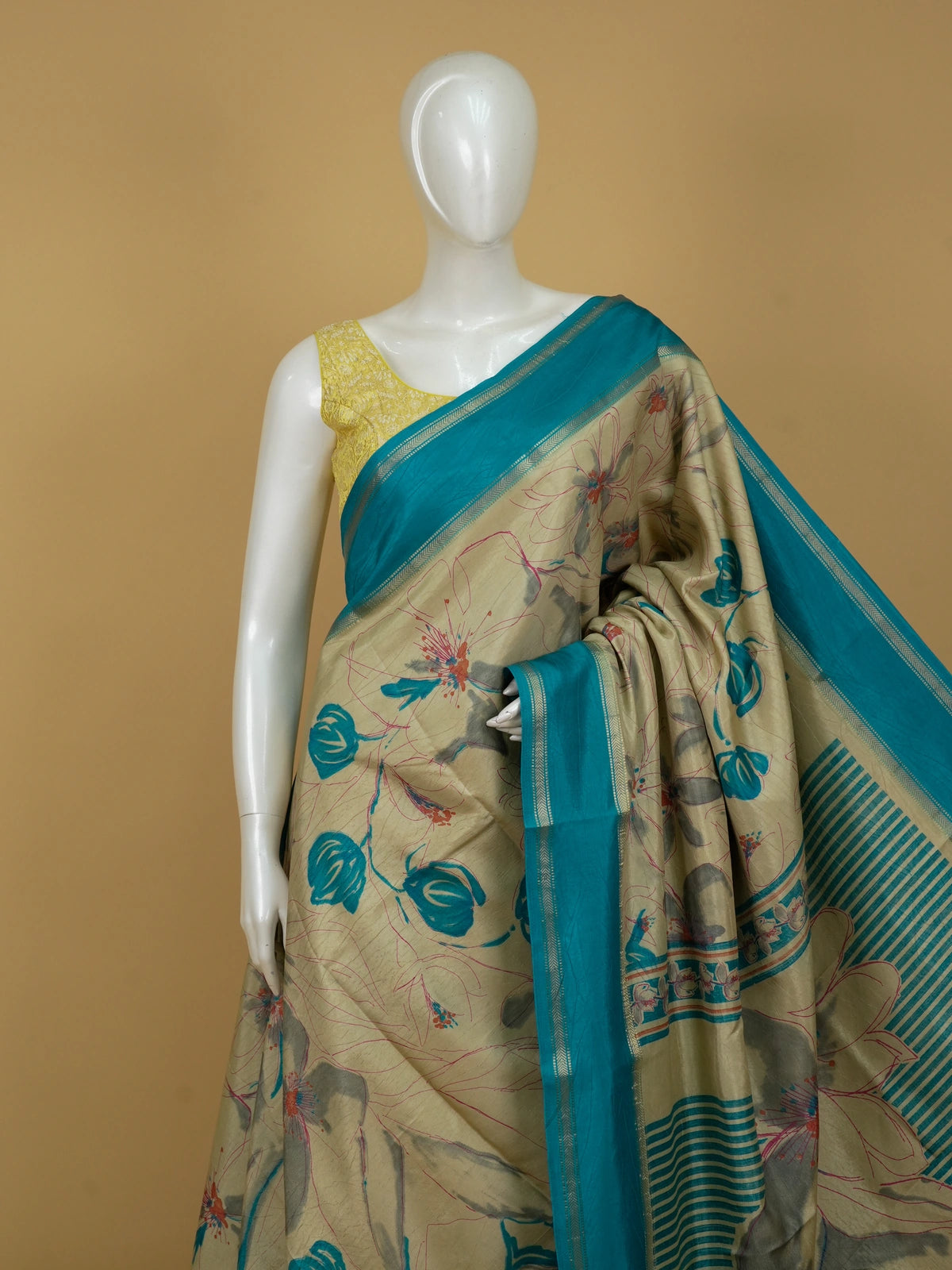 Beige and teal Dola silk saree with floral print and gold zari teal border