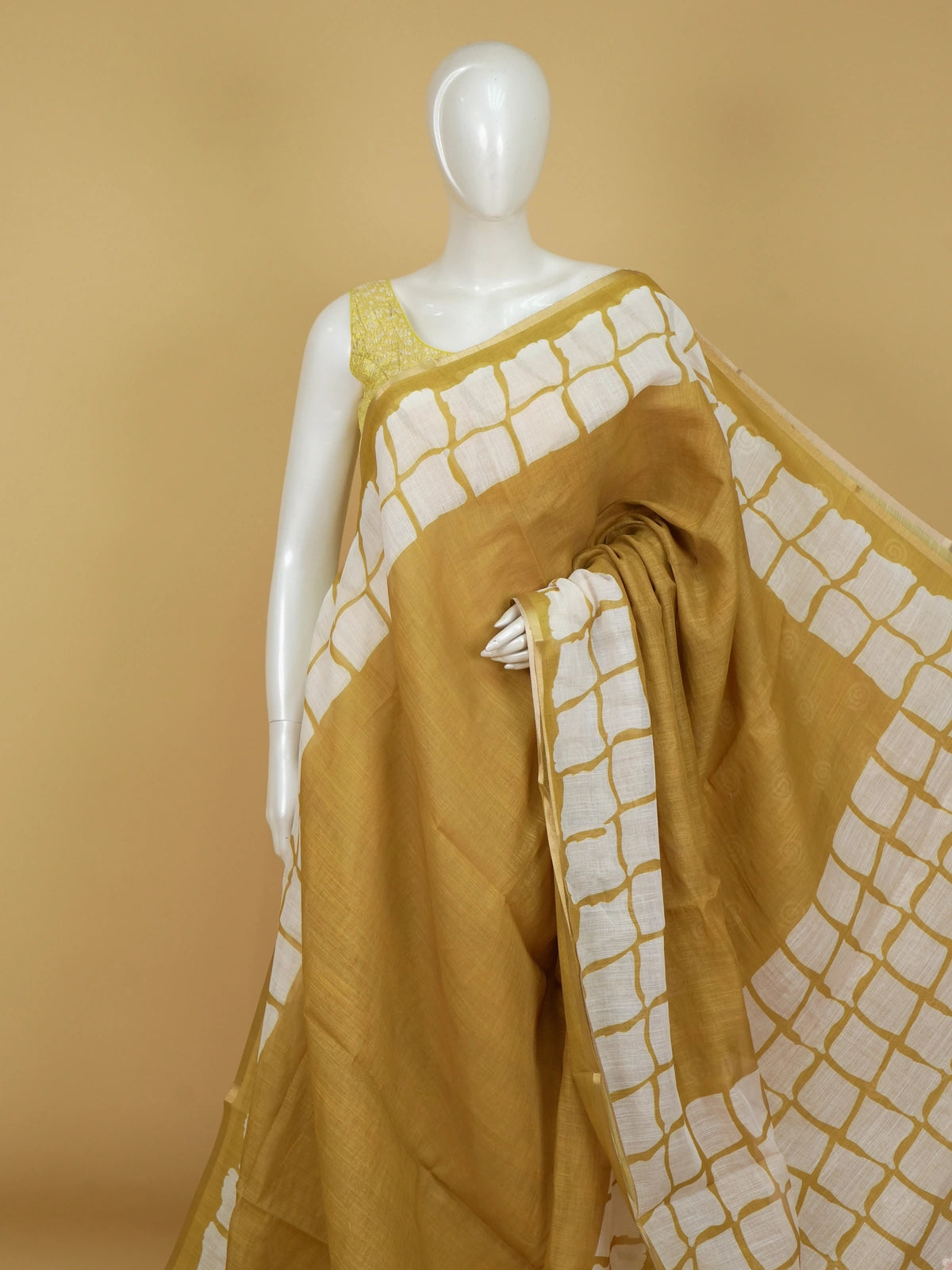 Mustard and white batik print linen cotton saree with contrast tile border and spiral motifs
