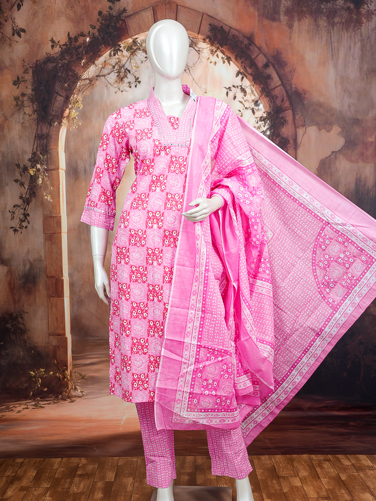 Pink floral print cotton kurti set with mirror-work neckline, straight pants, and matching printed dupatta